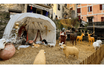 Nativity scene in one of the streets of Lucéram, featuring Mary, Joseph and the baby Jesus, with animals gathered all around.